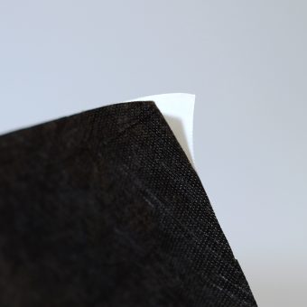 Close up of black self-adhesive non-woven.