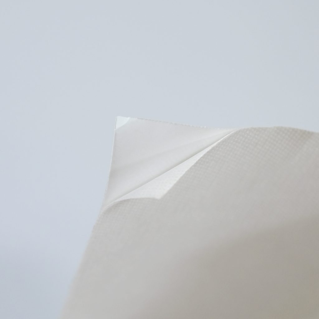 Close up of white self-adhesive non-woven.