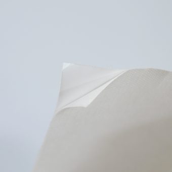Close up of white self-adhesive non-woven.
