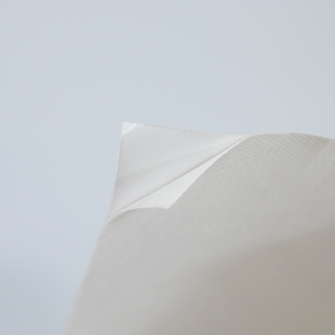 Close up of white self-adhesive non-woven.