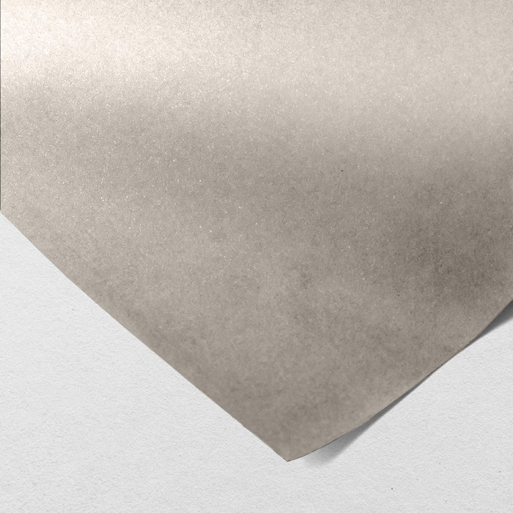 Close up of texture of a thin grey paperboard.