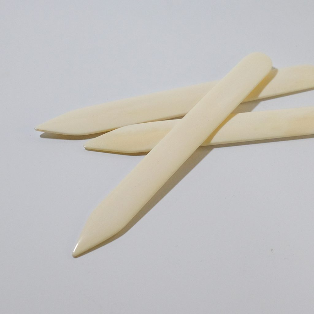 Close up of pointed bonefolders.