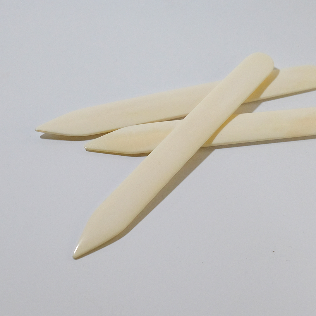 Close up of pointed bonefolders.