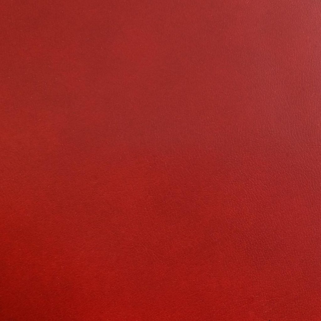 Close up of texture of Megara 24084 Red PVC material.