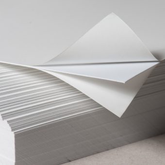 Close up of two-sided self-adhesive white paperboard