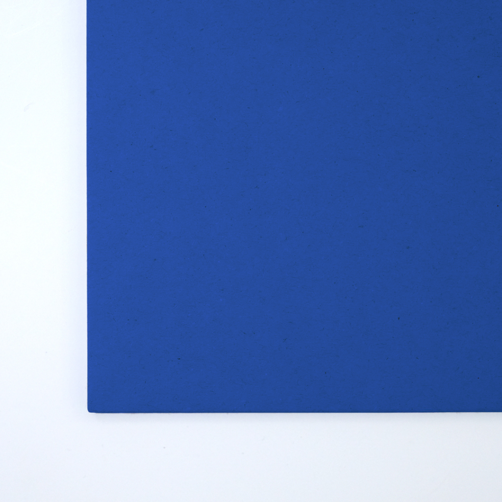 Close up of texture of a solid blue paperboard.