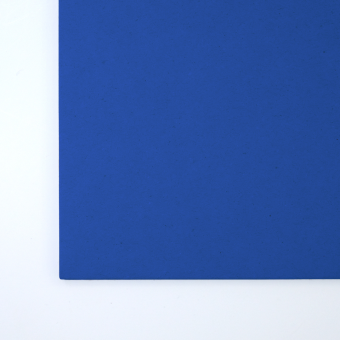 Close up of texture of a solid blue paperboard.