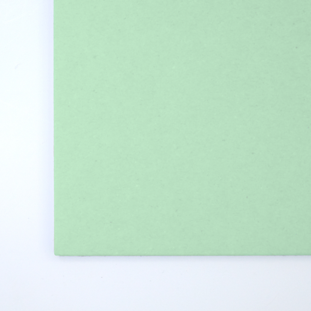 Close up of texture of a solid green paperboard.
