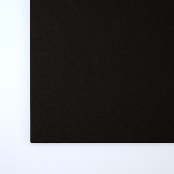 Close up of texture of a solid black paperboard.