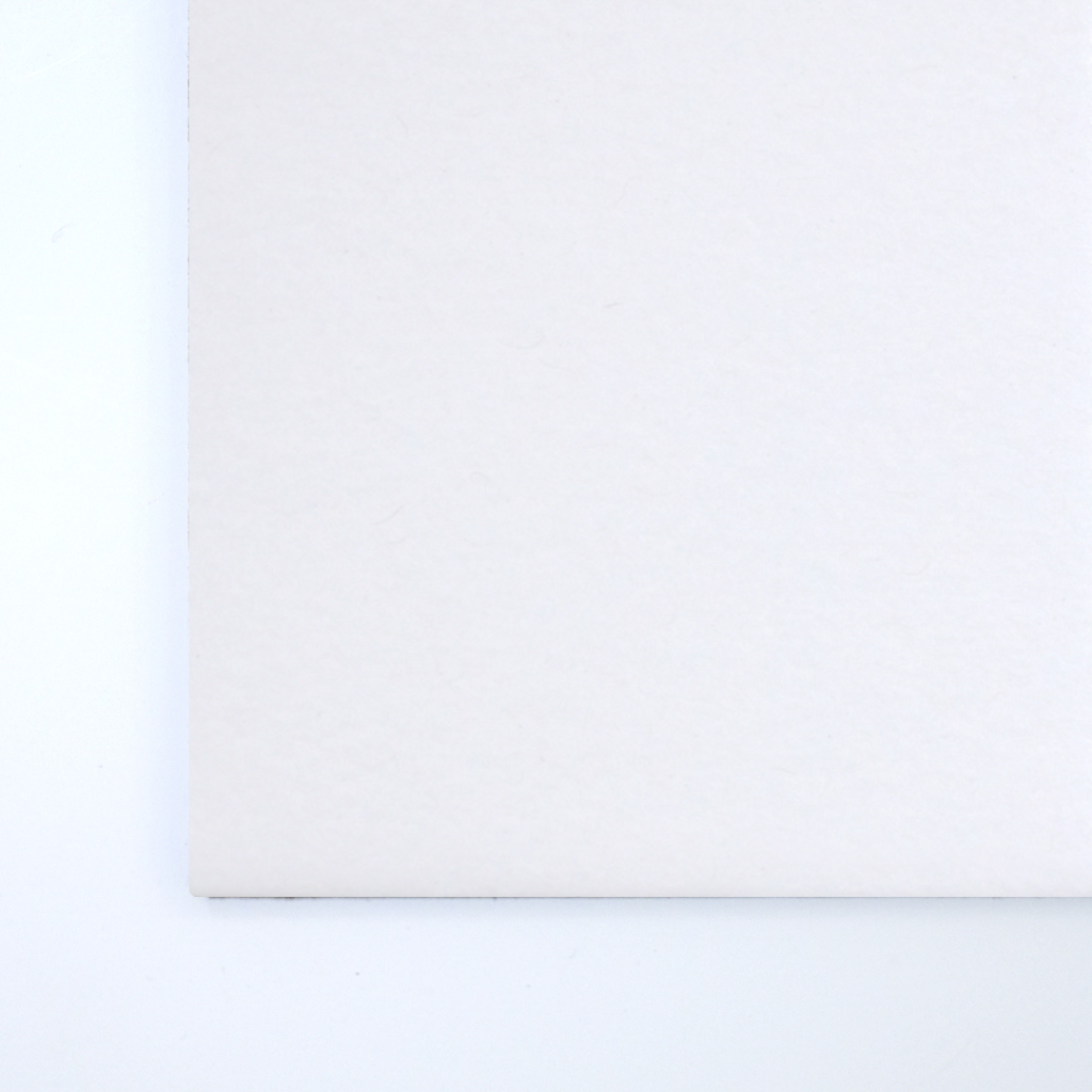 Close up of texture of a solid total white paperboard.
